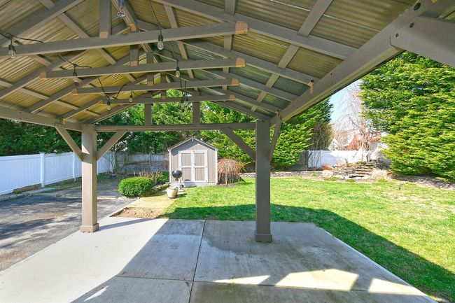View of patio / terrace with an outdoor structure, a fenced backyard, and a storage unit | Image 14