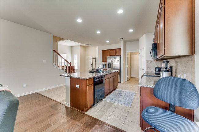 The granite counters in the kitchen are a nice touch along with the ample island! | Image 7
