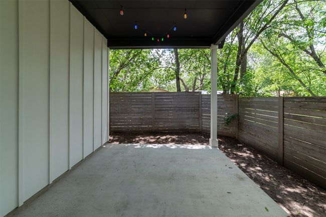 Fenced backyard with a patio | Image 19