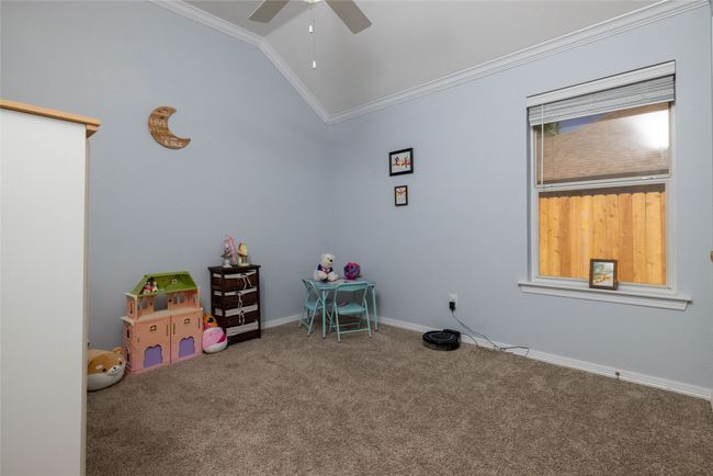 Game room with a ceiling fan, carpet floors, baseboards, lofted ceiling, and ornamental molding | Image 26