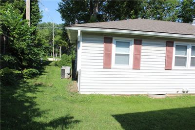 View of property exterior with a yard | Image 1