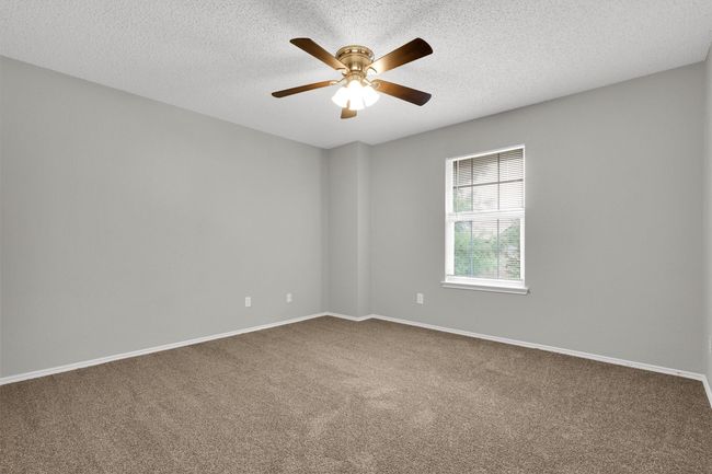 Spare room with carpet flooring, ceiling fan, a textured ceiling, and baseboards | Image 24