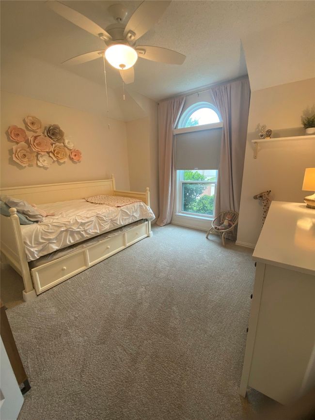 Bedroom with carpet flooring and a ceiling fan | Image 25