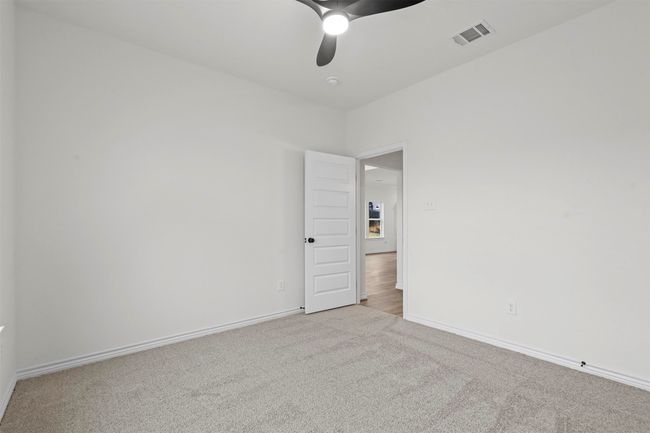 Unfurnished room featuring light colored carpet and ceiling fan | Image 33