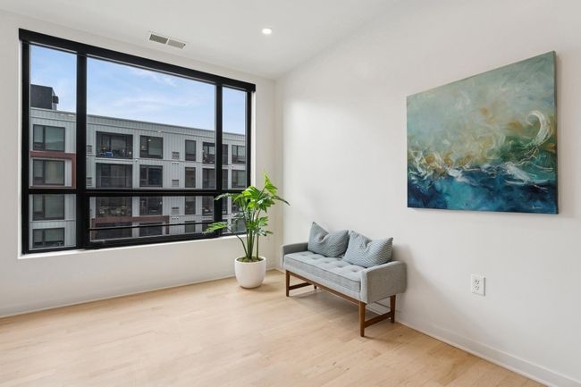 Expansive glass windows stretch nearly wall-to-wall, connecting you to the outdoors and filling the space with energizing natural light. | Image 12
