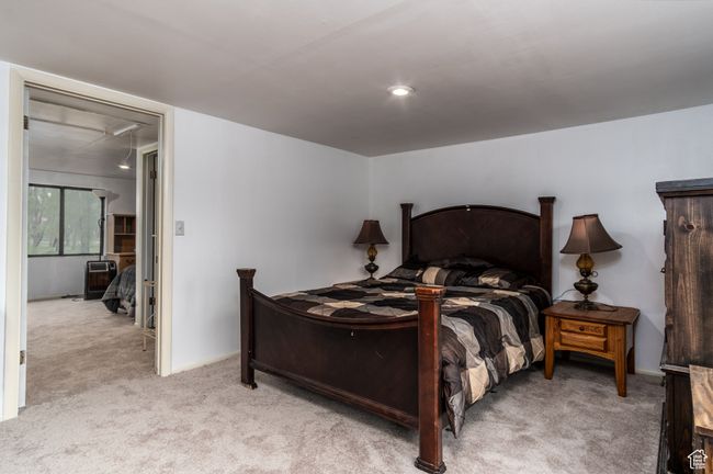 Bedroom featuring light colored carpet, attic access, and recessed lighting | Image 22
