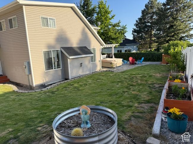Rear view of house with a garden and a patio area | Image 38