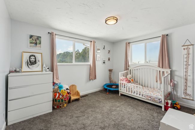 Bedroom featuring a nursery area, carpet floors, and baseboards | Image 10