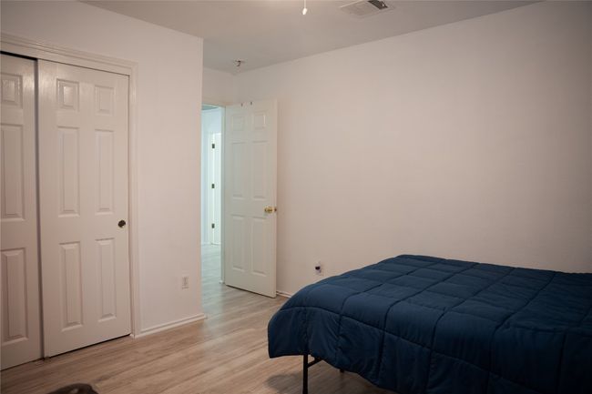 Bedroom featuring light wood finished floors, baseboards, and a closet | Image 11