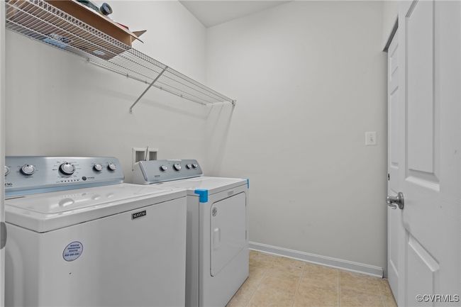 Laundry area with separate washer and dryer and baseboards | Image 29