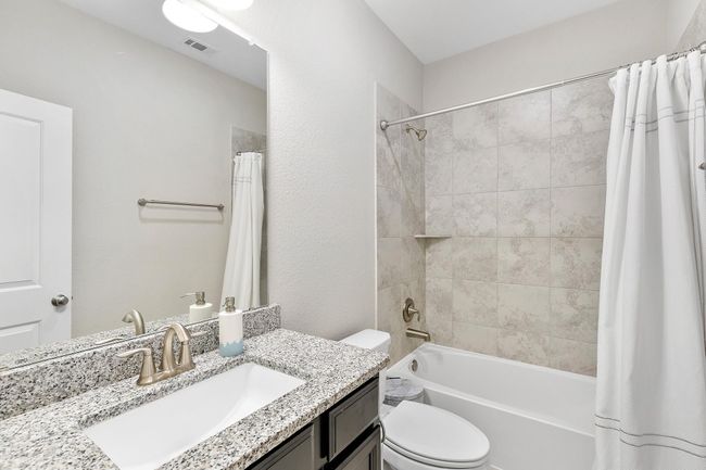 A spacious bathroom showcasing modern style, fresh colors, and a sleek design for everyday comfort. | Image 35
