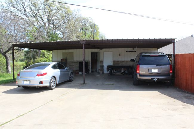 View of parking / parking lot with driveway and a carport | Image 15