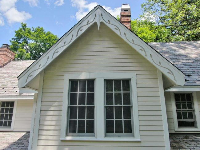 View of home's exterior featuring a chimney and a shingled roof | Image 37