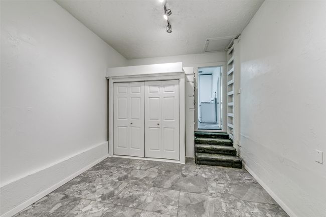 Unfurnished bedroom featuring attic access, a closet, and a textured ceiling | Image 17