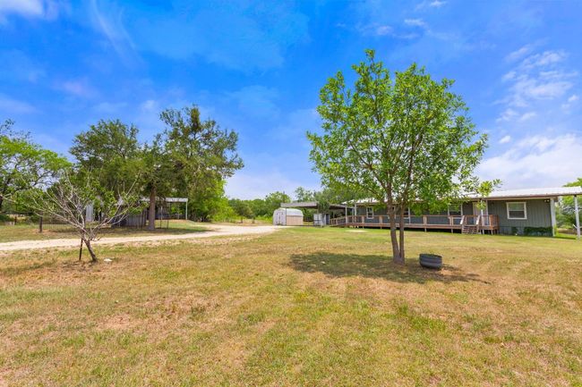 View of grassy yard with a deck | Image 8
