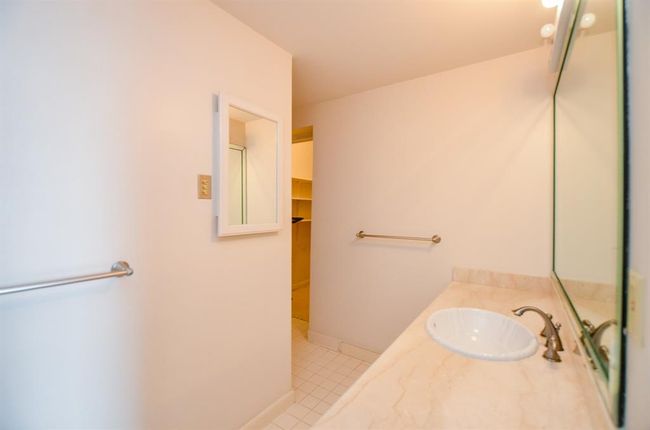 The secondary bedroom has an en-suite bath with a tub/ shower. | Image 17
