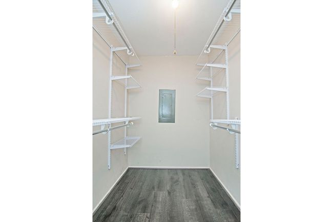 Walk in closet with dark hardwood / wood-style floors | Image 15