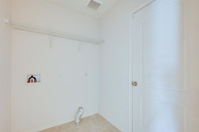 Laundry area with hookup for an electric dryer, hookup for a washing machine, and baseboards | Image 23