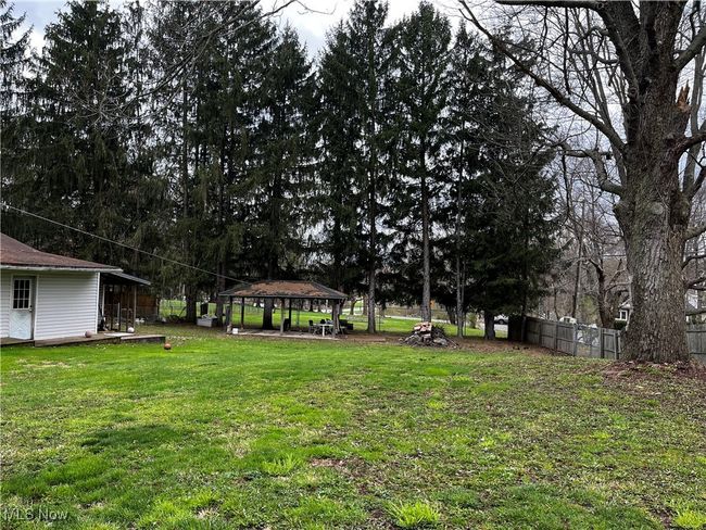 View of yard with a gazebo and fence | Image 13