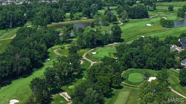 Aerial overview of property's location with a large body of water and a tree filled landscape | Image 58