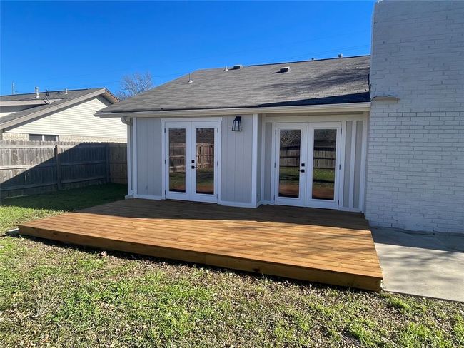 Rear view of property with a deck, brick siding, french doors, and fence | Image 18