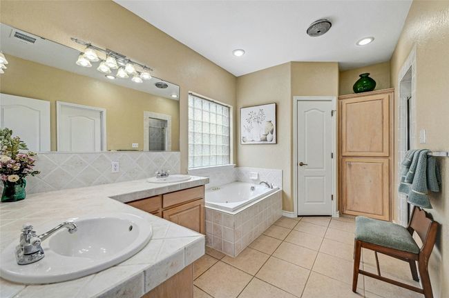 Primary bathroom features double vanities and a soaking tub. | Image 16