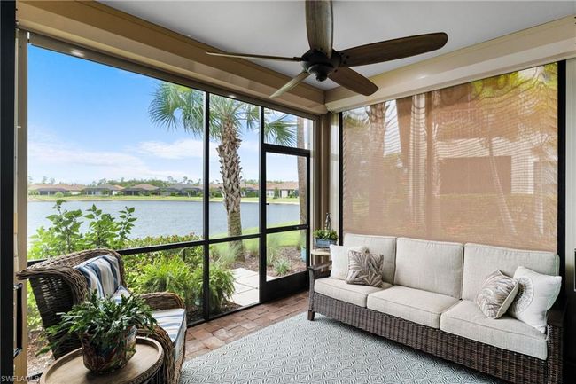 Sunroom featuring a ceiling fan, a water view, and outdoor lounge area | Image 26