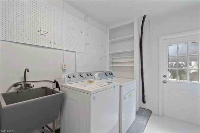 Laundry area with laundry area, washing machine and dryer, and a sink | Image 11