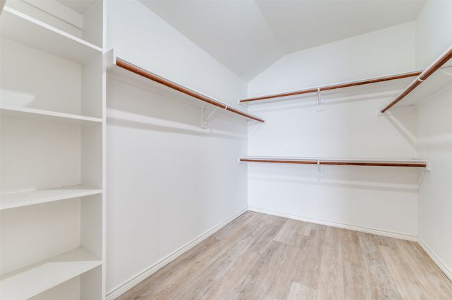 Spacious closet featuring wood finished floors and lofted ceiling | Image 20