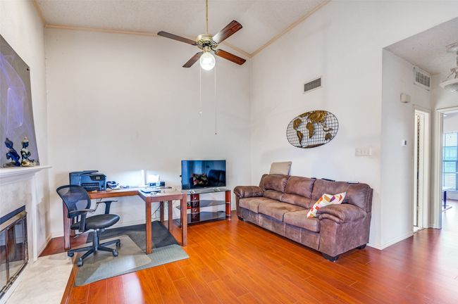 Spacious Living Room high vaulted ceiling, and a tile fireplace | Image 6