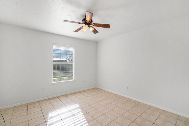 Empty room with light tile patterned floors and ceiling fan | Image 22