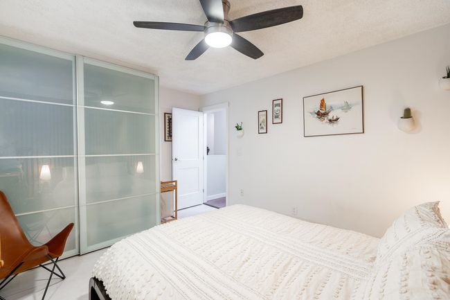 Bedroom with a textured ceiling and a ceiling fan | Image 15