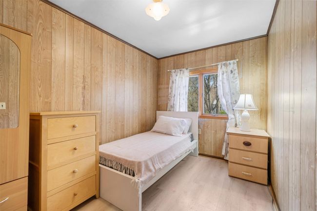 Bedroom featuring wooden walls and light wood finished floors | Image 18