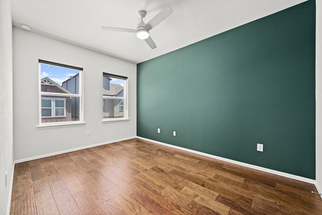 Empty room with ceiling fan and wood finished floors | Image 26