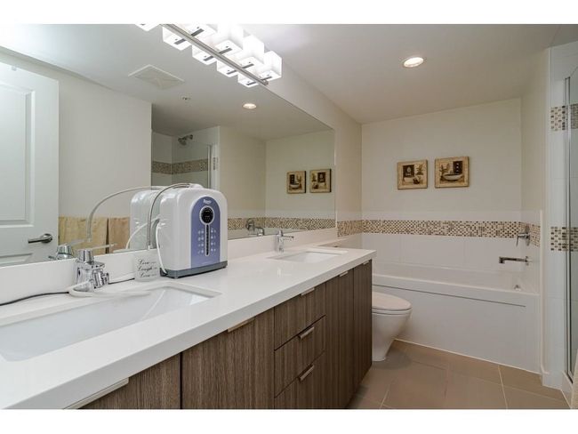Bathroom with tile patterned floors, walk in shower, and a sink | Image 12