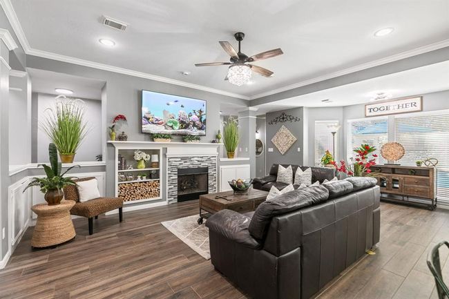 A well dressed gas firelog fireplace adds character. Wall of windows overlooking the pool. | Image 13