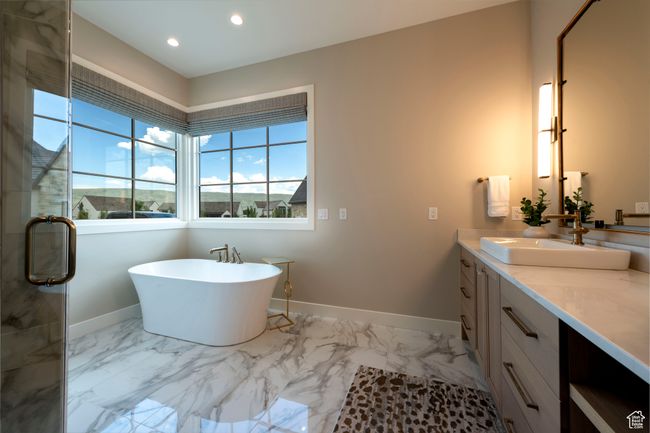 Bathroom with vanity, marble finish floors, a soaking tub, recessed lighting, and a stall shower | Image 32