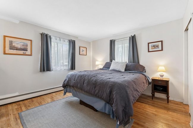 Bedroom with light wood-type flooring | Image 14