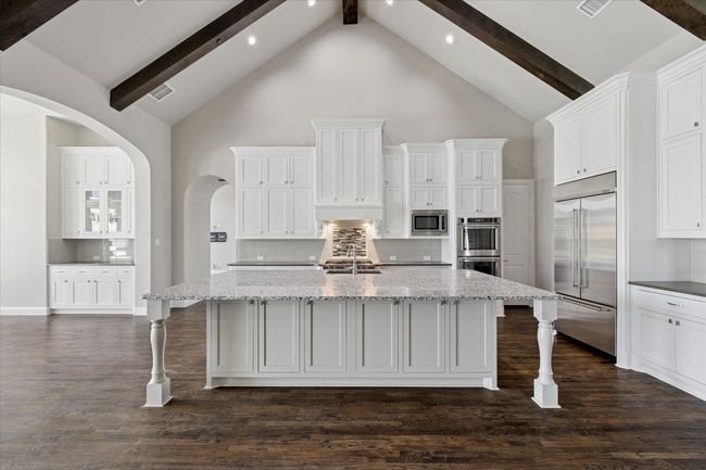 Fantastic kitchen with huge island with space for 8 barstools, coffee bar and double oven | Image 12