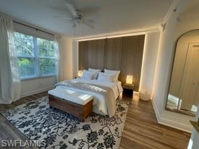 Bedroom with dark hardwood / wood-style flooring, ornamental molding, and ceiling fan | Image 3