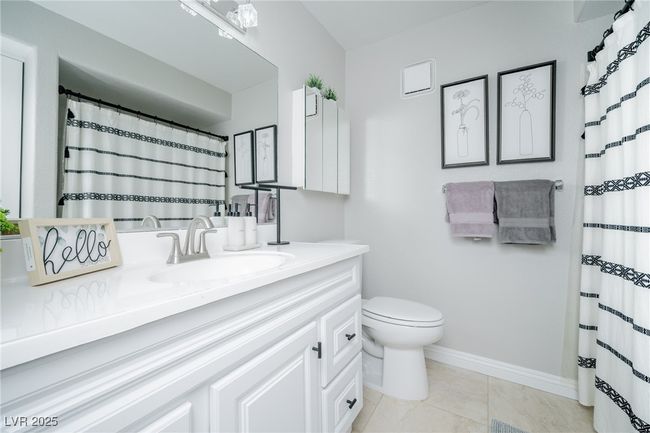 Full bathroom featuring vanity, curtained shower, toilet, baseboards, and tile patterned flooring | Image 23