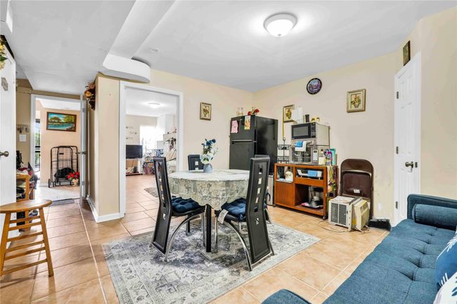 Dining space with light tile patterned flooring | Image 19