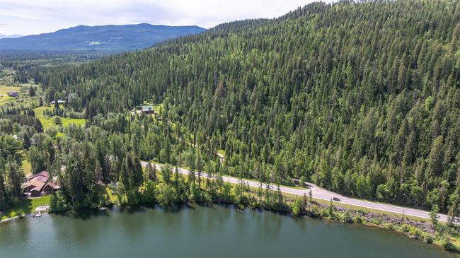 Aerial view of property and surrounding area featuring a forest and a water and mountain view | Image 77