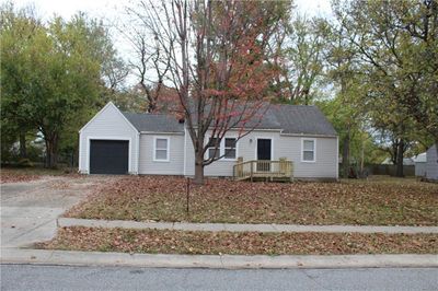 Single story home with a garage and a deck | Image 1