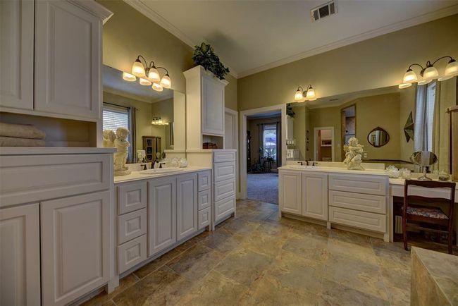 The Primary Bath measures 20X20. Spacious shower, soaking tub, his and her vanities and large walk in closet | Image 24