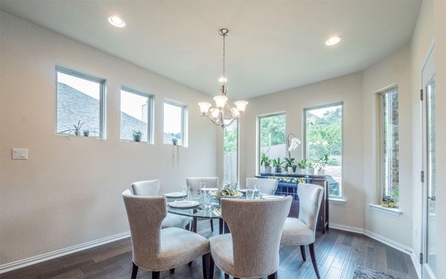 The dining area straight off the kitchen feels open but also private. It overlooks the backyard. | Image 9