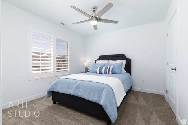 Bedroom with visible vents, ceiling fan, carpet floors, and baseboards | Image 34