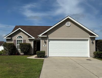 Single story home with a garage and a front yard | Image 1