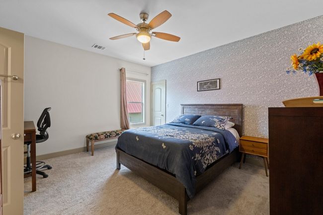 Carpeted bedroom with visible vents, baseboards, and a ceiling fan | Image 19