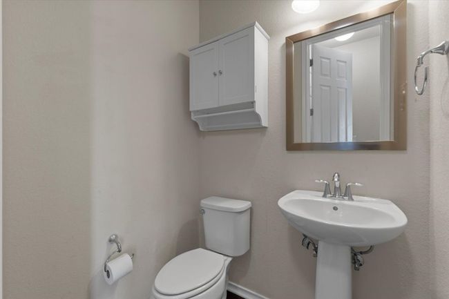 Bathroom with toilet and a textured wall | Image 19